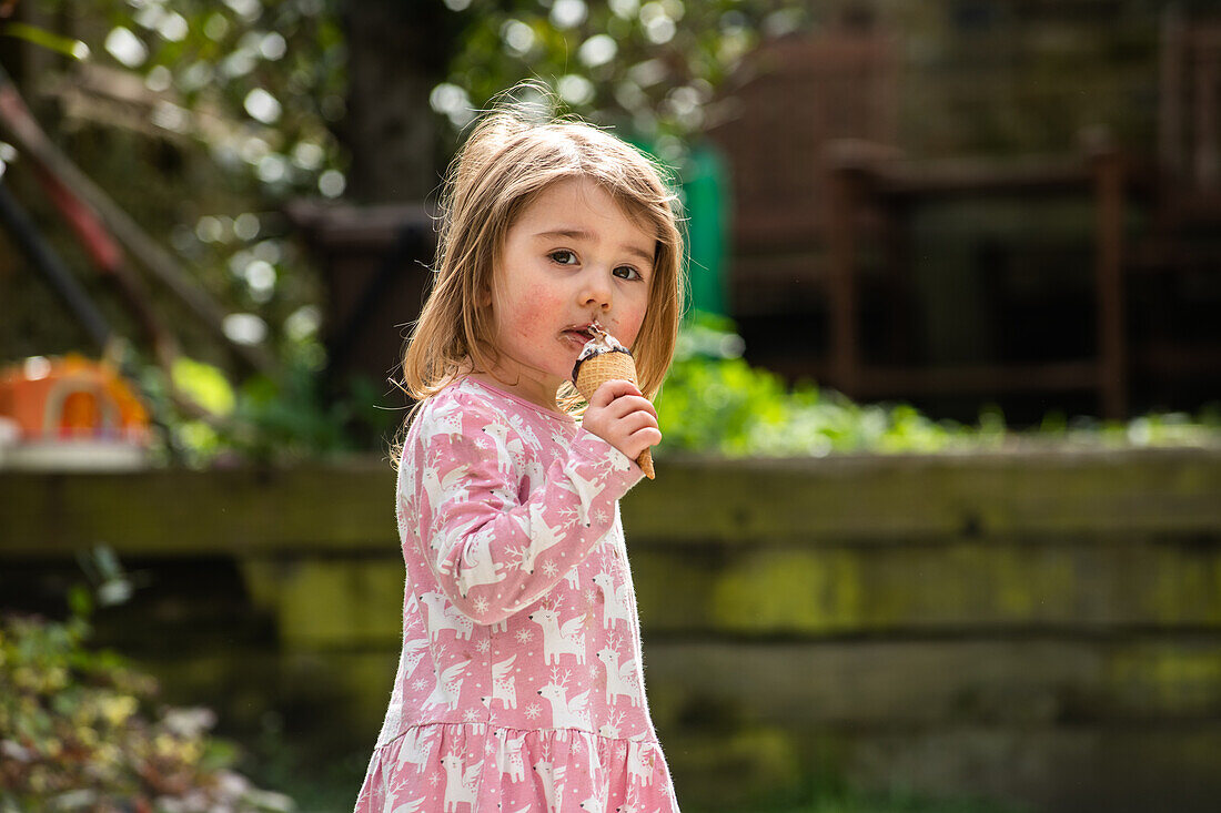 UK, Portrait of girl (2-3) with ice cream cone