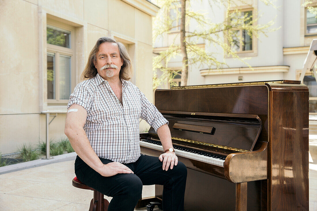 Austria, Portrait of pianist with adhesive bandage on arm