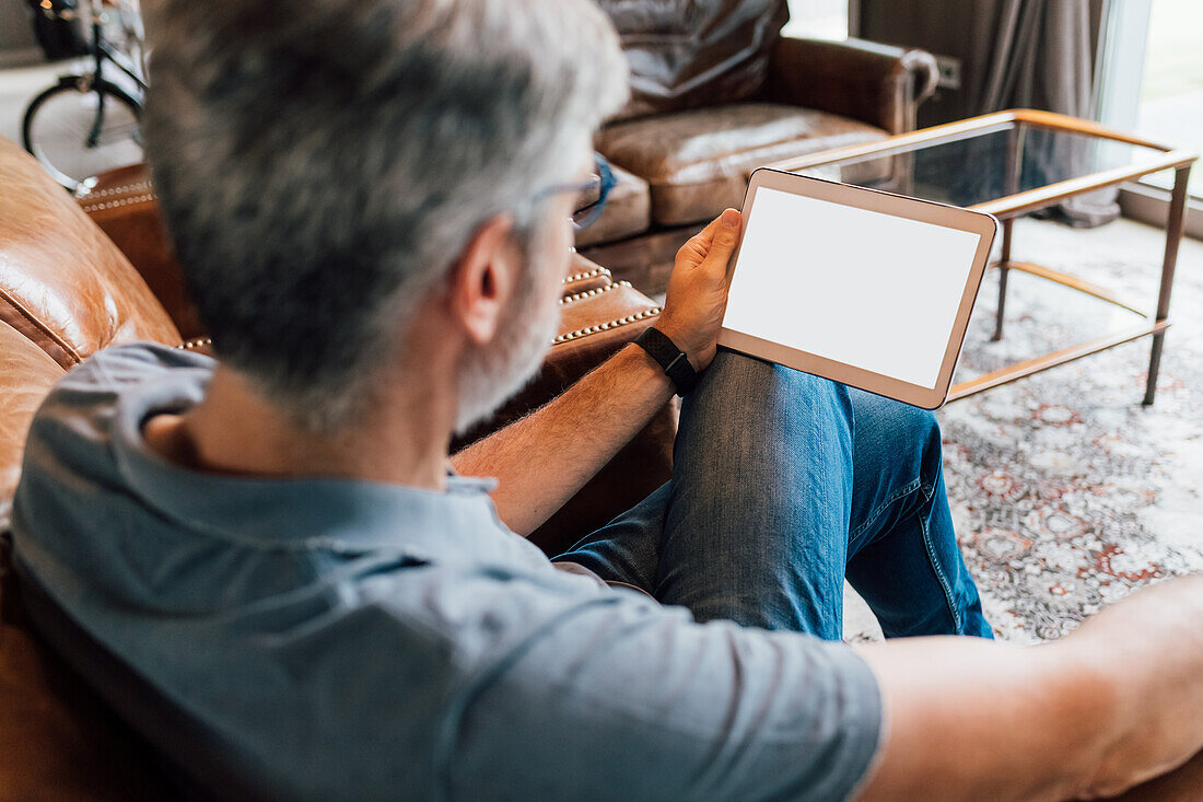 Italy, Businessman using digital tablet in creative studio