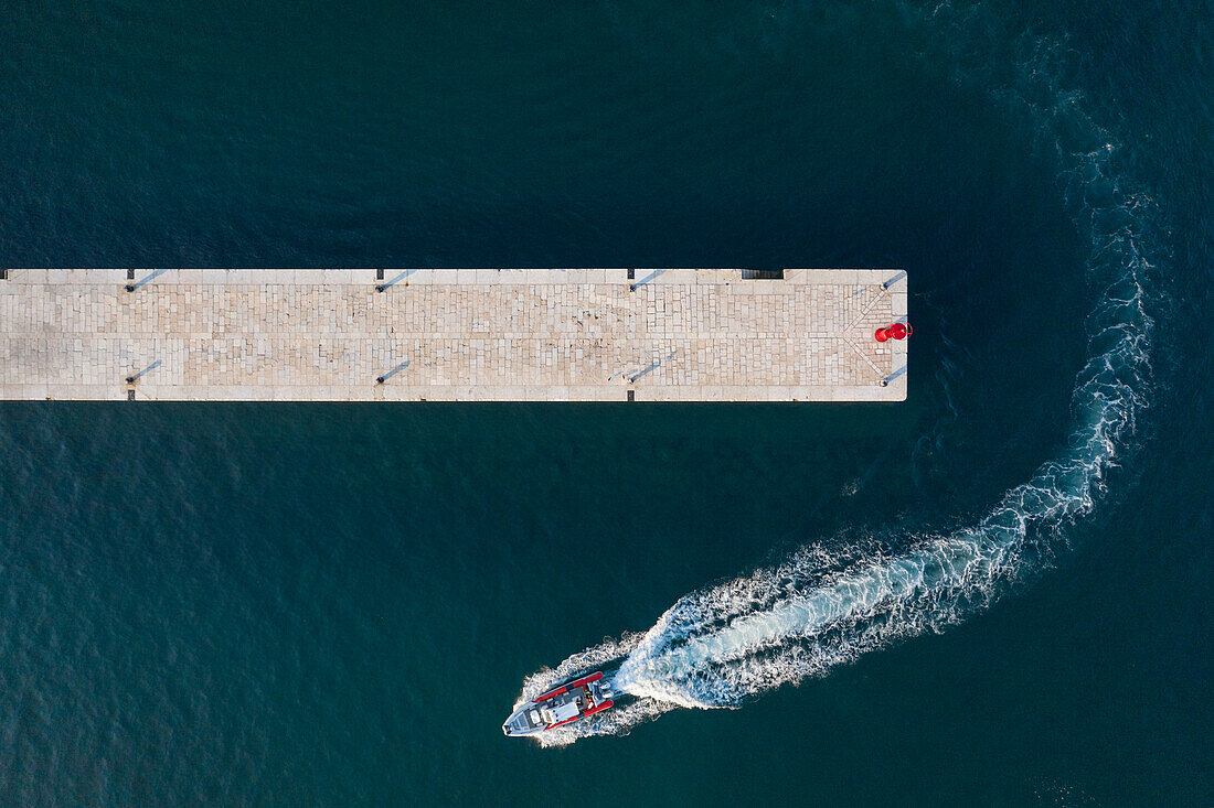 Croatia, Istria, Rovinj, Aerial view of dock and motorboat