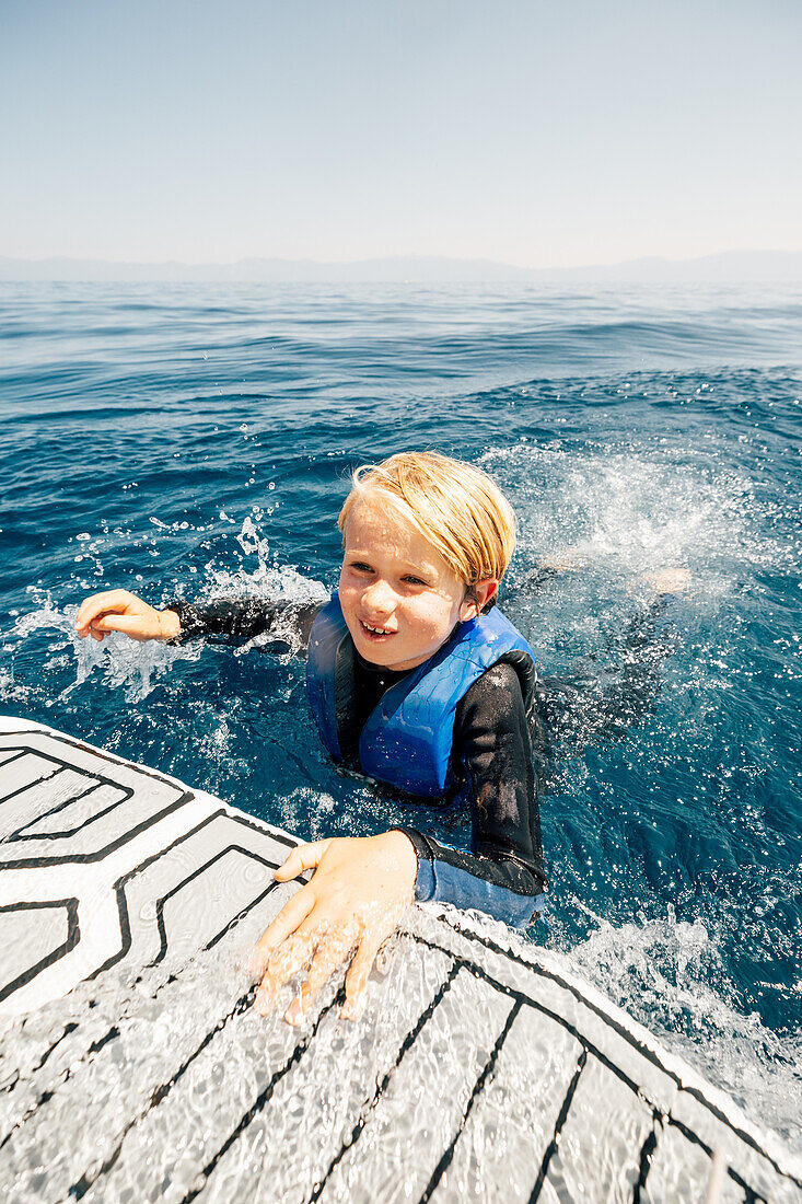 Boy (12-13) swimming in lake