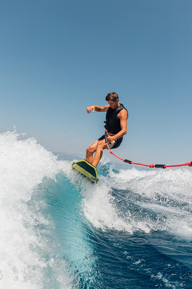 Man wakeboarding at lake