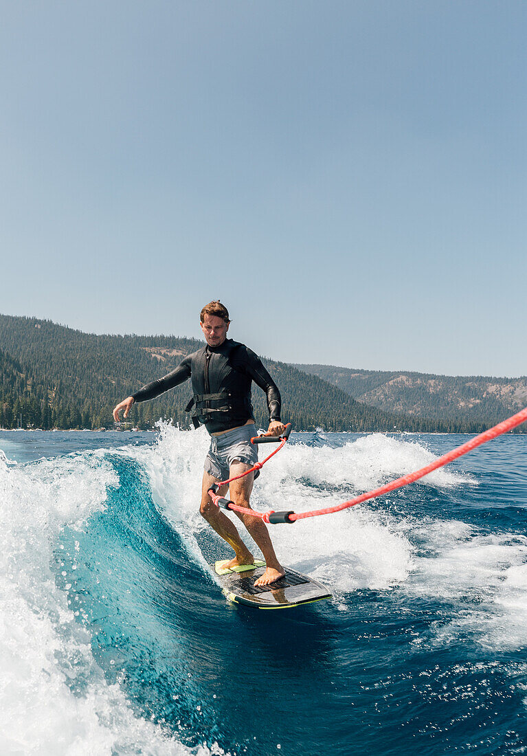 Man wakeboarding at lake