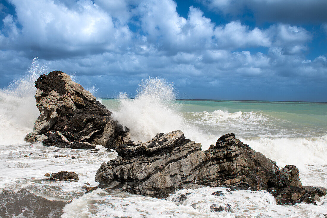 Sea waves crashing against rocks, Sicily, Italy