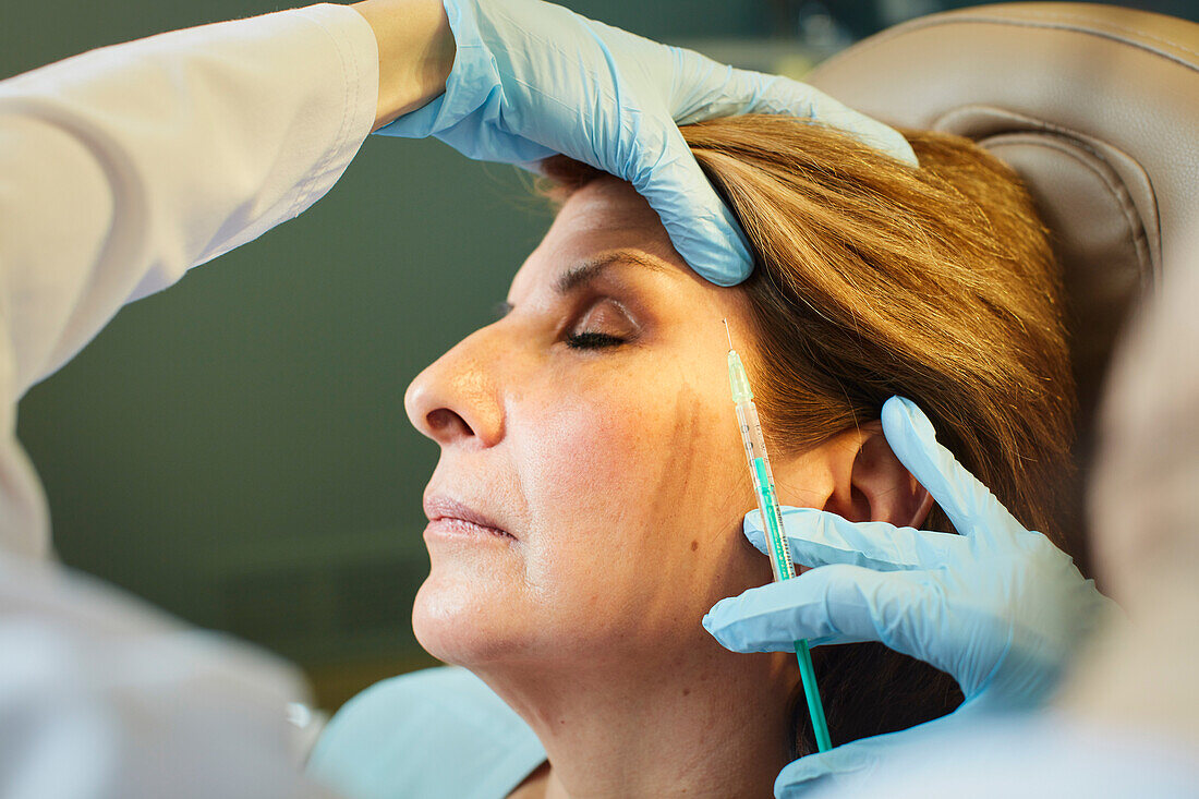 Close-up of woman receiving botox injection