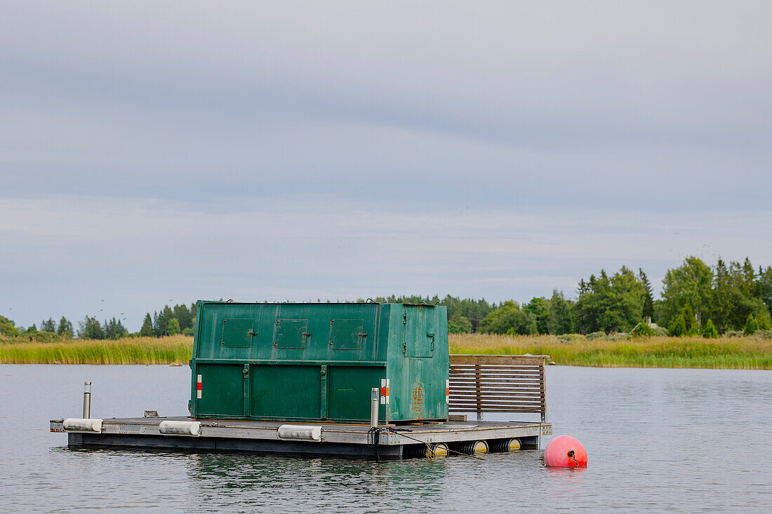 Small boathouse floating on lake