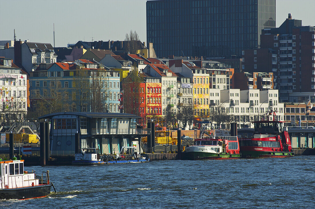 Boats Moored Along The River And Colourful Buildings; Hamburg Germany