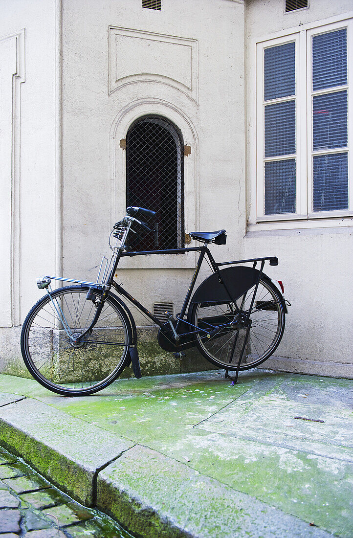 A Bicycle Parked Outside A White Building, Marais District; Paris, France