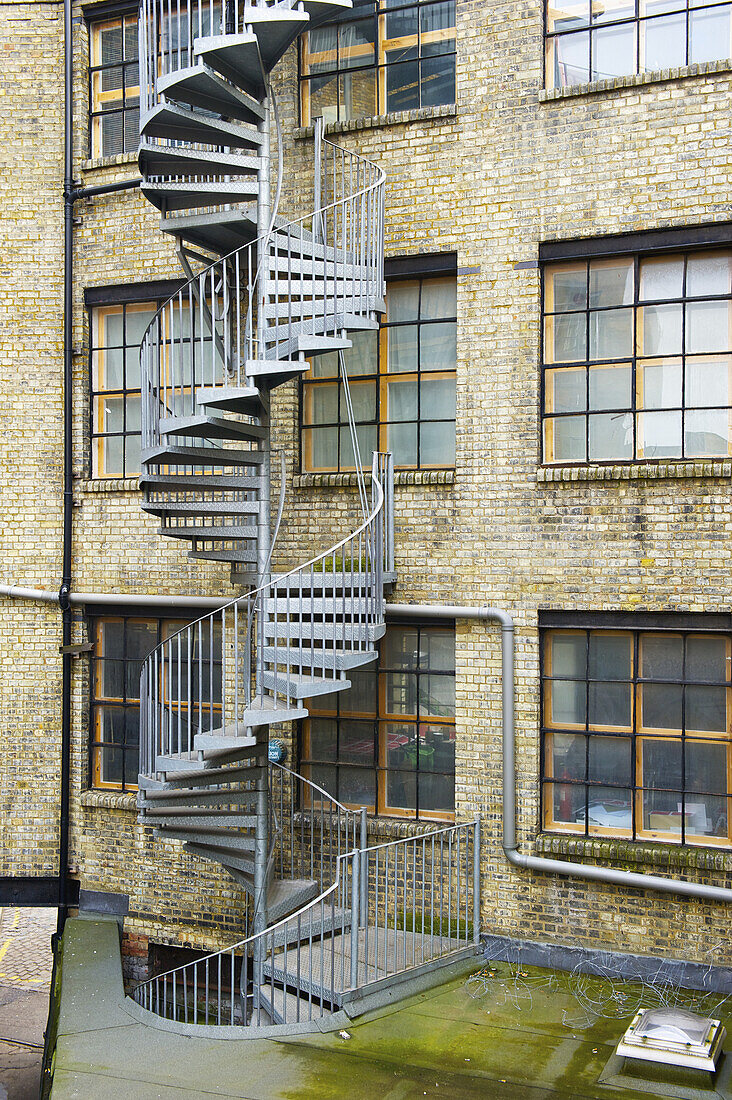 A Winding Stairway On The Exterior Of A Residential Brick Building In Shoreditch; London, England