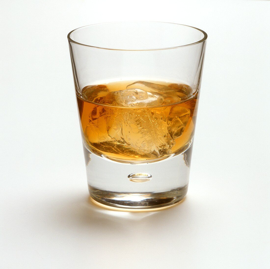 Whisky with ice cubes in glass