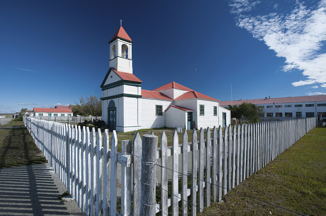 A Church With Bell Tower And White Picket Fence; Rio Grande, Argentina