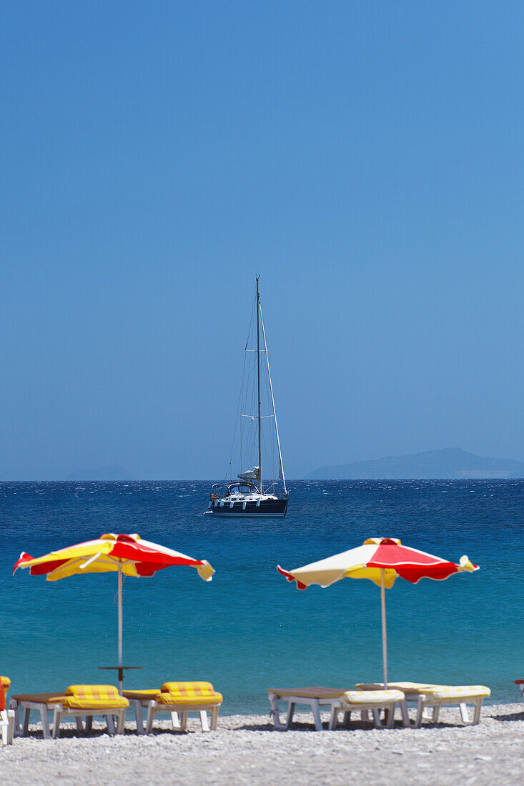 Sonnenschirme und Liegestühle an einem Strand auf der Insel Kos; Kefalos, Griechenland