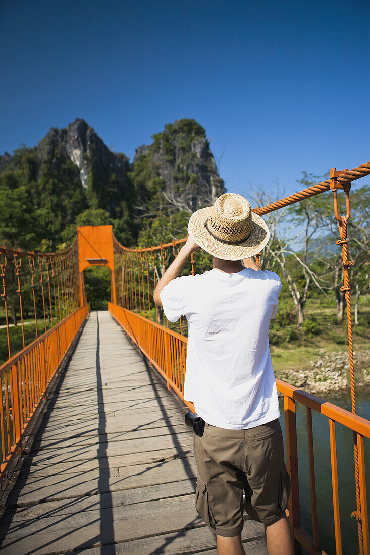 A Bridge Leads To Caves Outside Of Vang Vieng; Laos