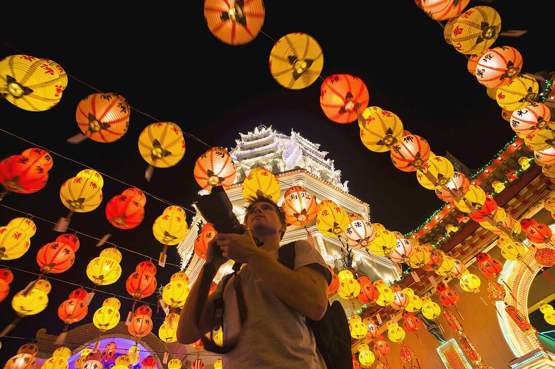 The Fantastic Lighting Of Kek Lok Si Temple And A Tourist With A Camera; Penang, Malaysia