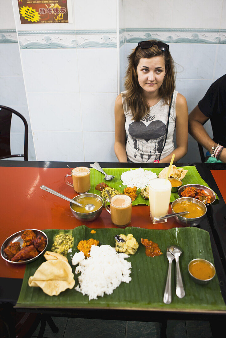 Eating Indian Food At A Local Restaurant In The Georgetown Little India Area; Penang, Malaysia