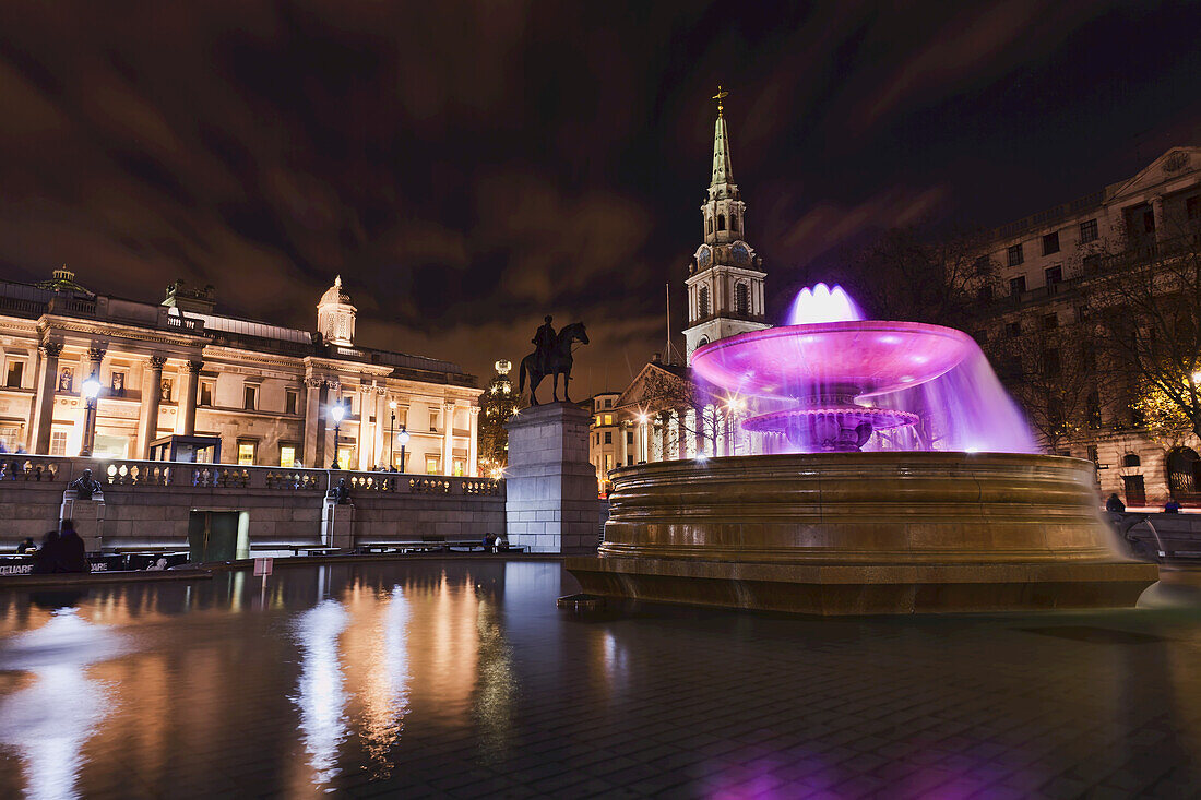 Trafalgar Square With Fountain At Night, The National Gallery And St Martin-In-The-Fields; London, England