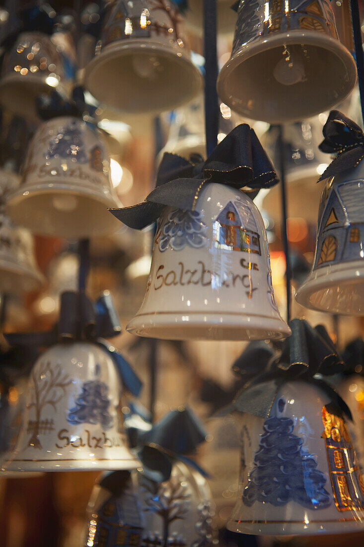 Christmas Decorations In The Form Of Ceramic Bells With Snow-Covered Trees And Log Cabins; Salzburg, Austria