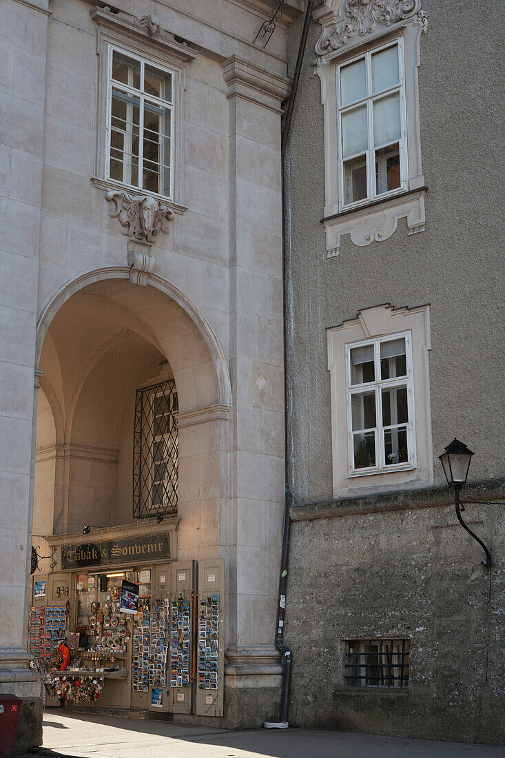 Tabacconist And Souvenir Shop Selling Postcards, Guidebooks, Maps, Toys, Badges And Decorative Plates, Under An Arch In The Colonnades Of Domplatz; Salzburg, Austria