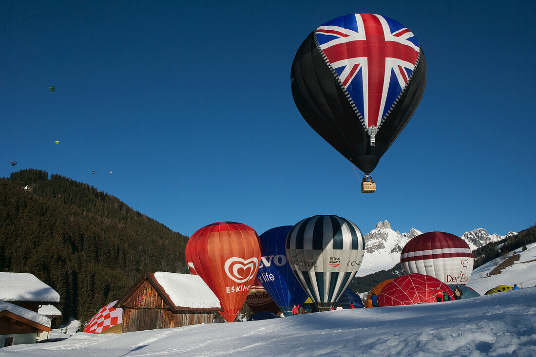 Hot Air Balloons Taking Off During The Ski Resort's Annual Hot Air Balloon Festival, Including One With The British Union Jack; Filzmoos, Austria