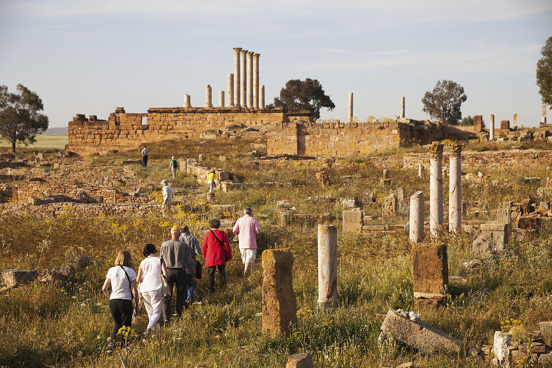 Tourists Walking Amongst The Ruins Towards The Capitoline Temple; Thuburbo Majus, Tunisia