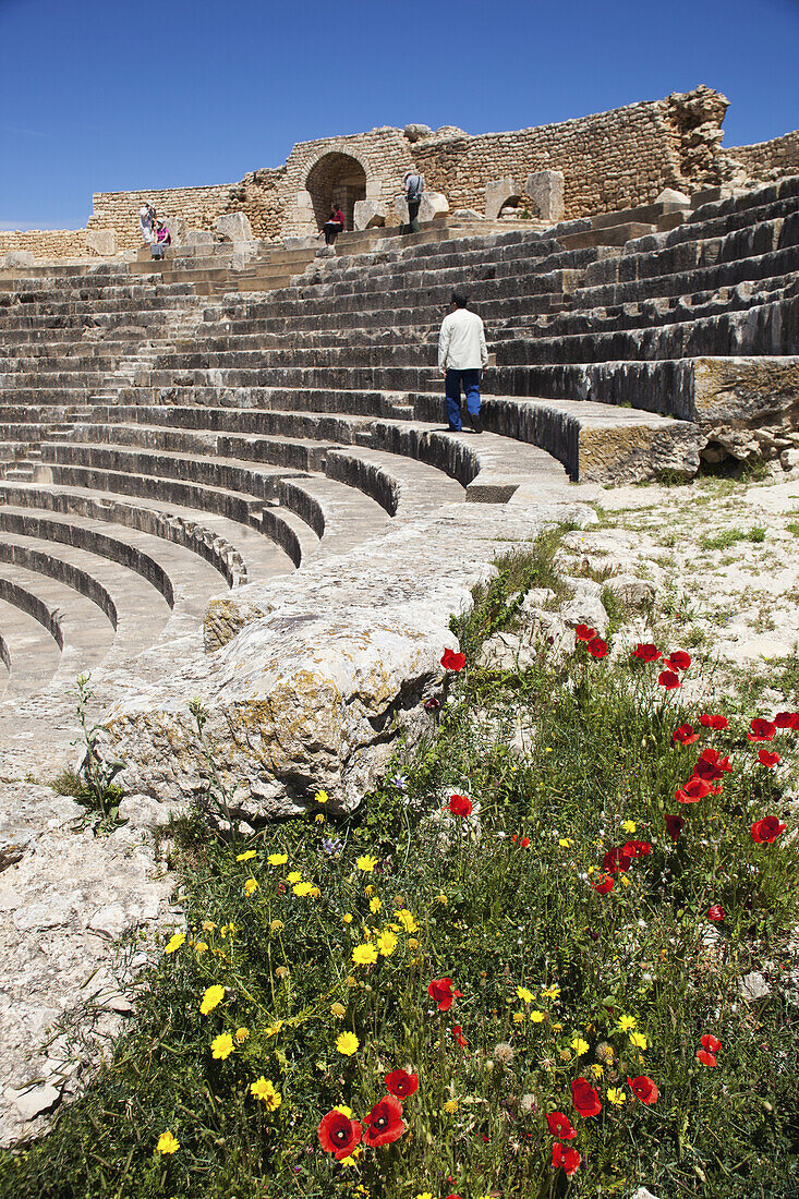 Tourist Walks Through The Roman Theatre; Dougga, Tunisia