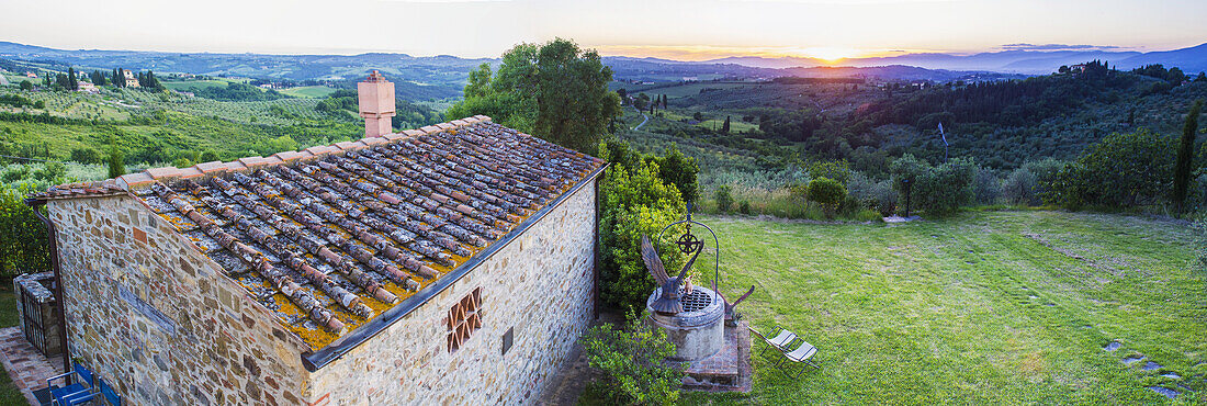 Ein Steinhaus und ein Blick auf die üppige Landschaft bei Sonnenuntergang, Villa Capanuccia; Florenz, Italien