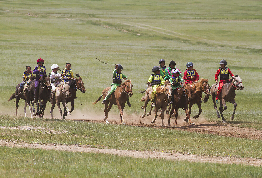 Boys Racing Horses In The Daaga (Two-Year Old) Horse Race Held During The 2014 Naadam Mongolian National Festival At Khui Doloon Khudag, The Horse Racing Ground, Ulan Bator, Mongolia