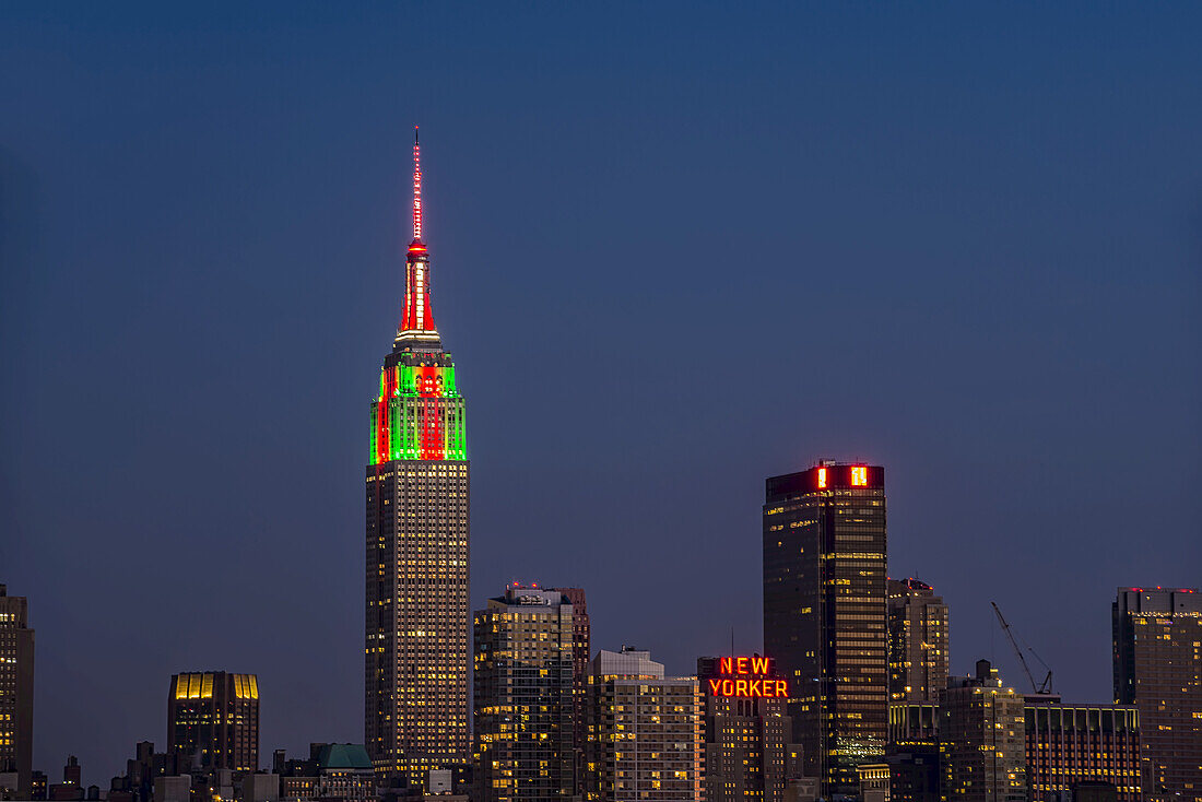 Empire State Building At Twilight In Colours Celebrating Christmas; New York City, New York, United States Of America