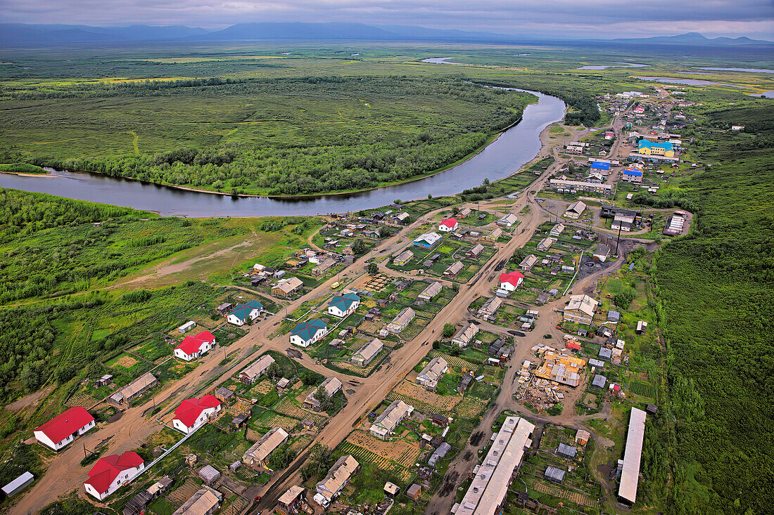 Remote fishing town of Khailino. An aerial photograph of Khailino from a MI-8 helicopter between Tilichiki and Khailino, shows the Vyvenka River linking these two communities.  Flying north in Kamchatka, there are miles and miles of untouched tundra, streams, wetland, and rivers like this meandering, unconstrained river that is a perfect environment for salmon spawning; Khailino, Kamchatka Krai, Russia