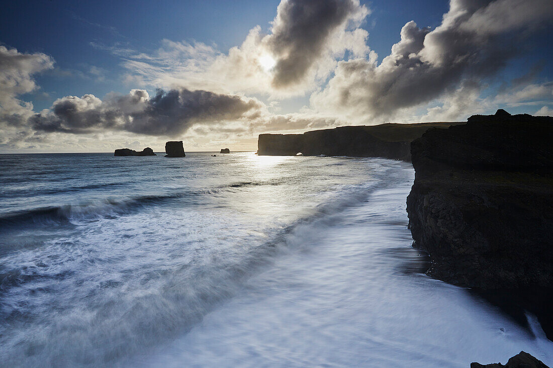 Scenic view of the coastline of Dyrholaey Island with the surf and rugged cliffs, near Vik, in Southern Iceland; Dyrholaey Island, Iceland