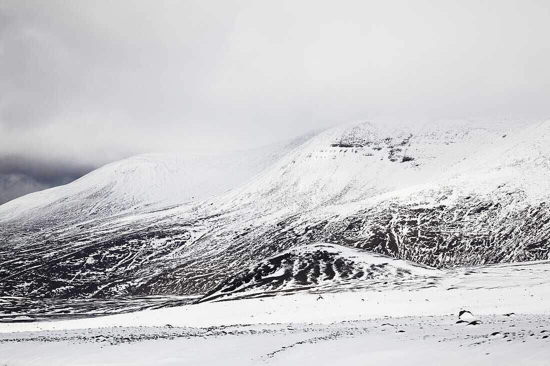 Snow-clad mountains in early winter in the Kaldidalur Valley, seen from Langjokull Glacier, in the western Highlands of west Iceland; Iceland