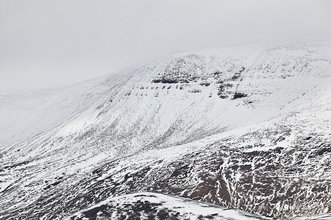 Snow-clad mountains in early winter in the Kaldidalur Valley, seen from Langjokull Glacier, in the western Highlands of west Iceland; Iceland