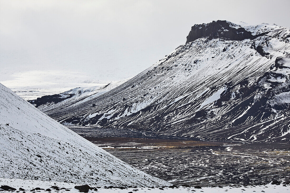 Snow-clad mountains in early winter in the Kaldidalur Valley, seen from Langjokull Glacier, in the western Highlands of west Iceland; Iceland