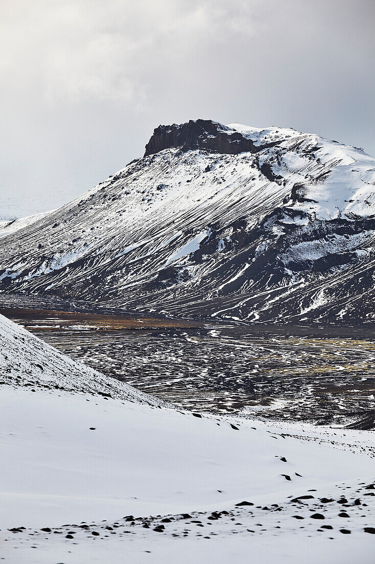 Snow-clad mountains in early winter in the Kaldidalur Valley, seen from Langjokull Glacier, in the western Highlands of west Iceland; Iceland