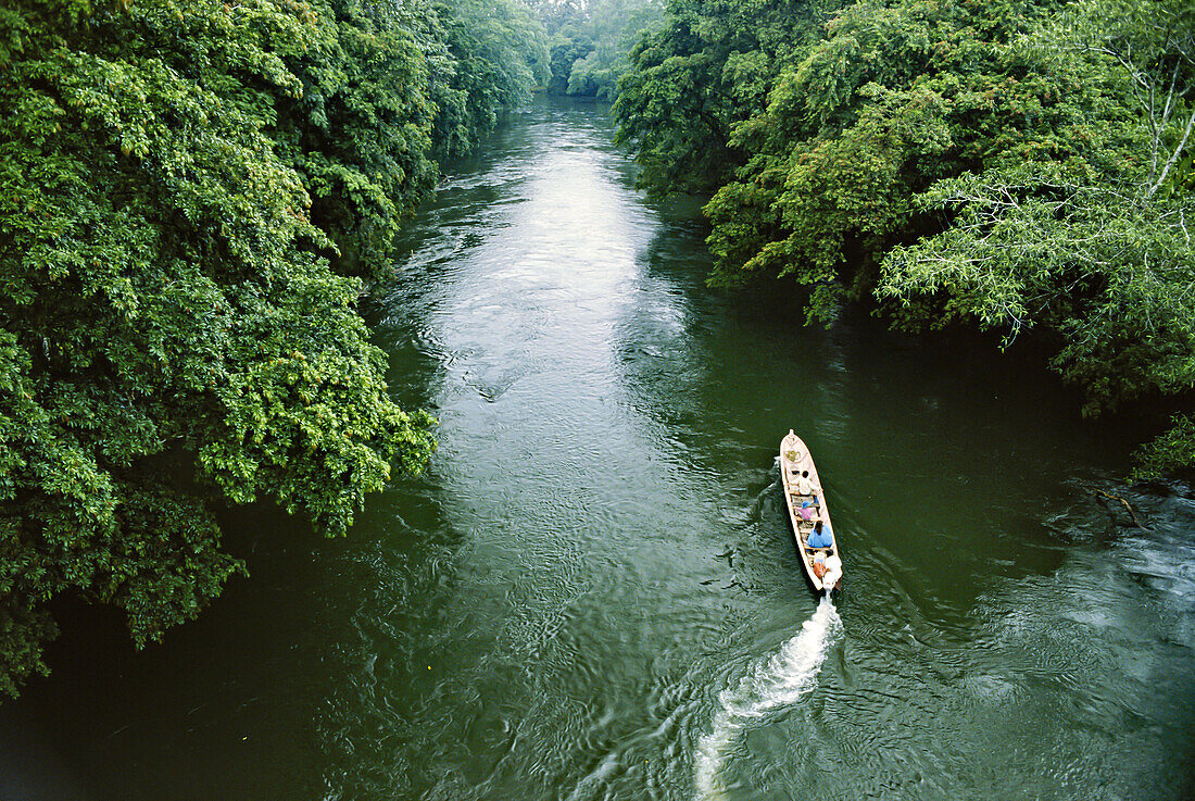 Aerial view of a boat carrying people down a river in Costa Rica; Costa Rica