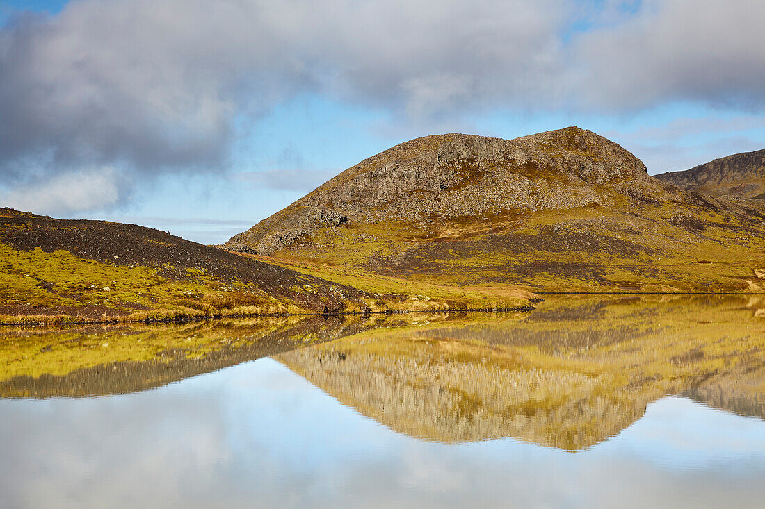 Landforms and their mirror reflection in a lake at Valafell mountain pass, near Olafsvik, Snaefellsnes peninsula, west coast of Iceland; Iceland