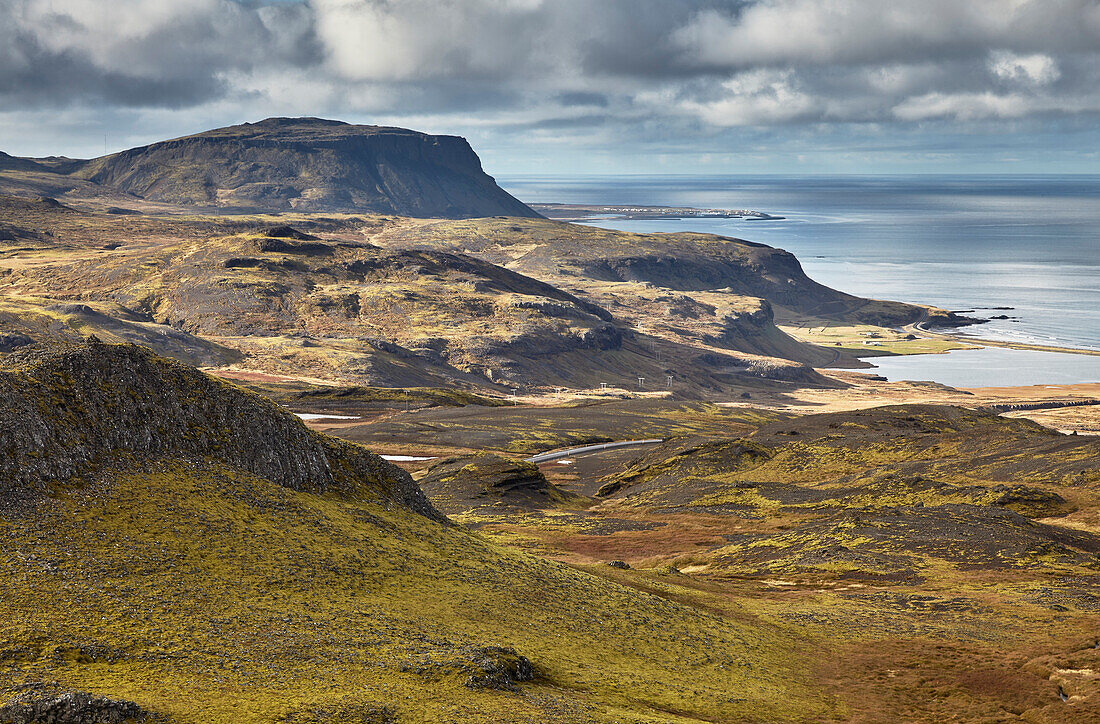 Harsh and rugged landscape along the coast of Iceland, with a view of the north coast from Valafell mountain pass, looking towards Olafsvik, Snaefellsnes peninsula, west coast of Iceland; Iceland