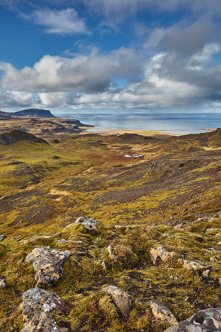 Harsh and rugged landscape along the coast of Iceland, with a view of the north coast from Valafell mountain pass, looking towards Olafsvik, Snaefellsnes peninsula, west coast of Iceland; Iceland