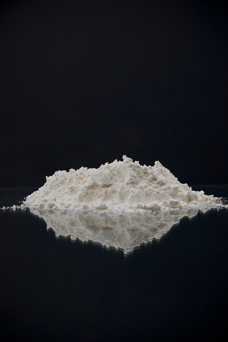 Pile of flour with mirror image reflection