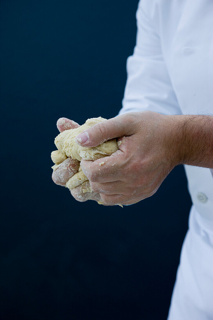 Close up of a chef hands kneading pizza dough