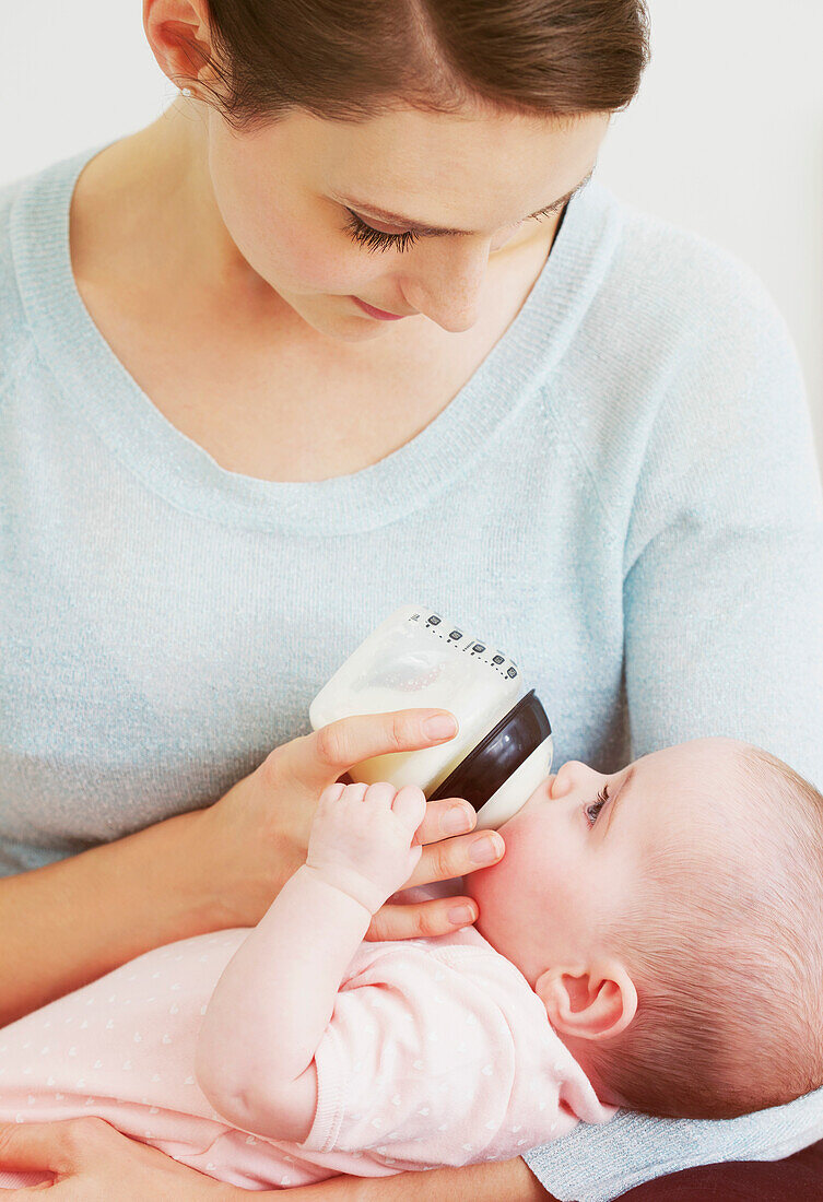 Mother Bottle Feeding Baby Girl