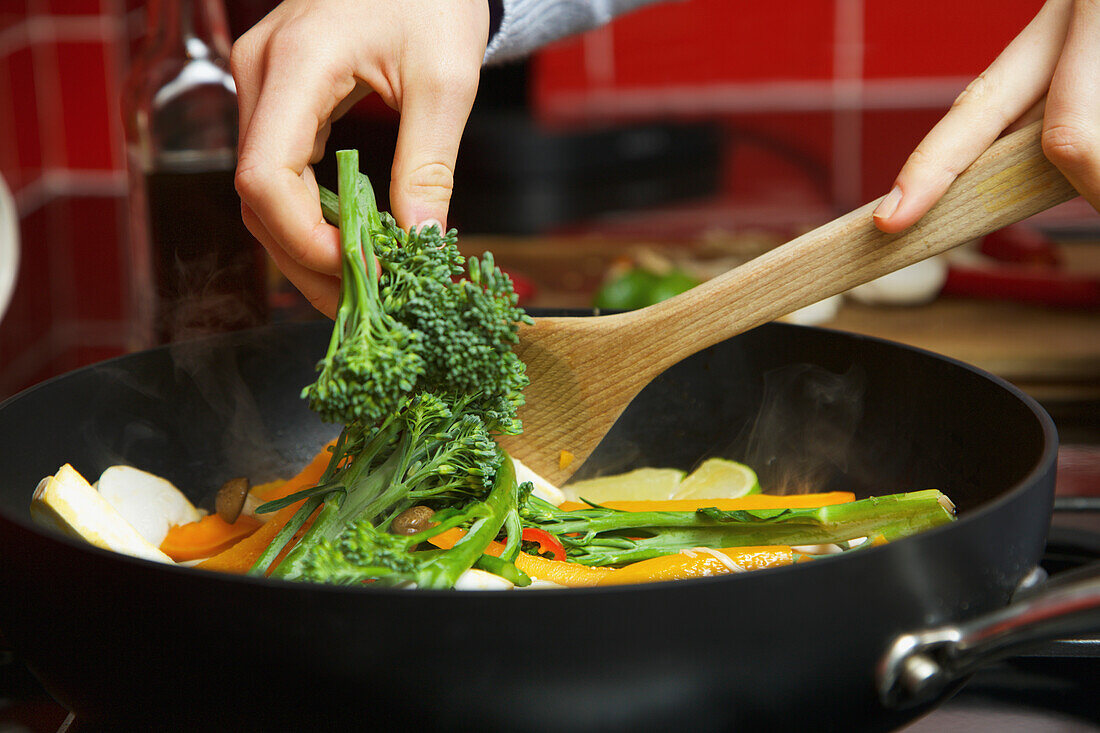 Woman Making Stir Fry Vegetables, Close-up view