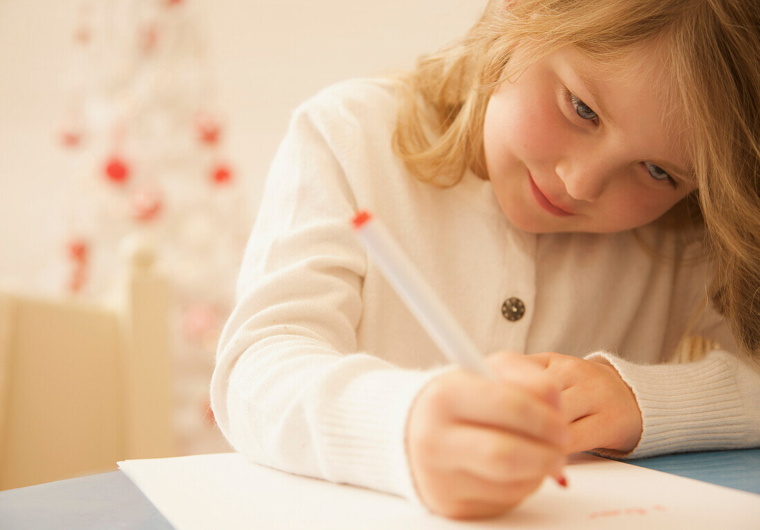 Girl writing a letter to Father Christmas