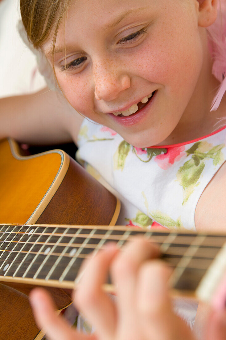 Cute Young Girl Playing Guitar