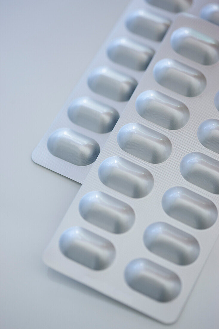 Pills in Blister Packs on white table