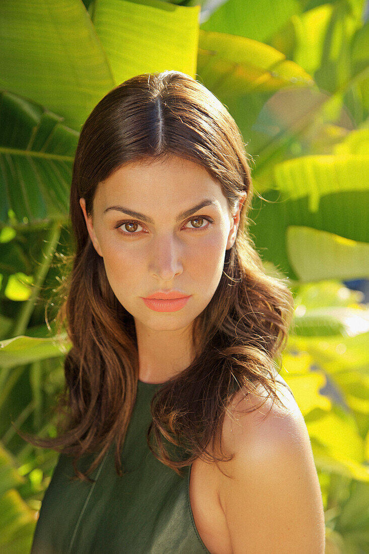 Portrait of Woman with Palm Leaves in background