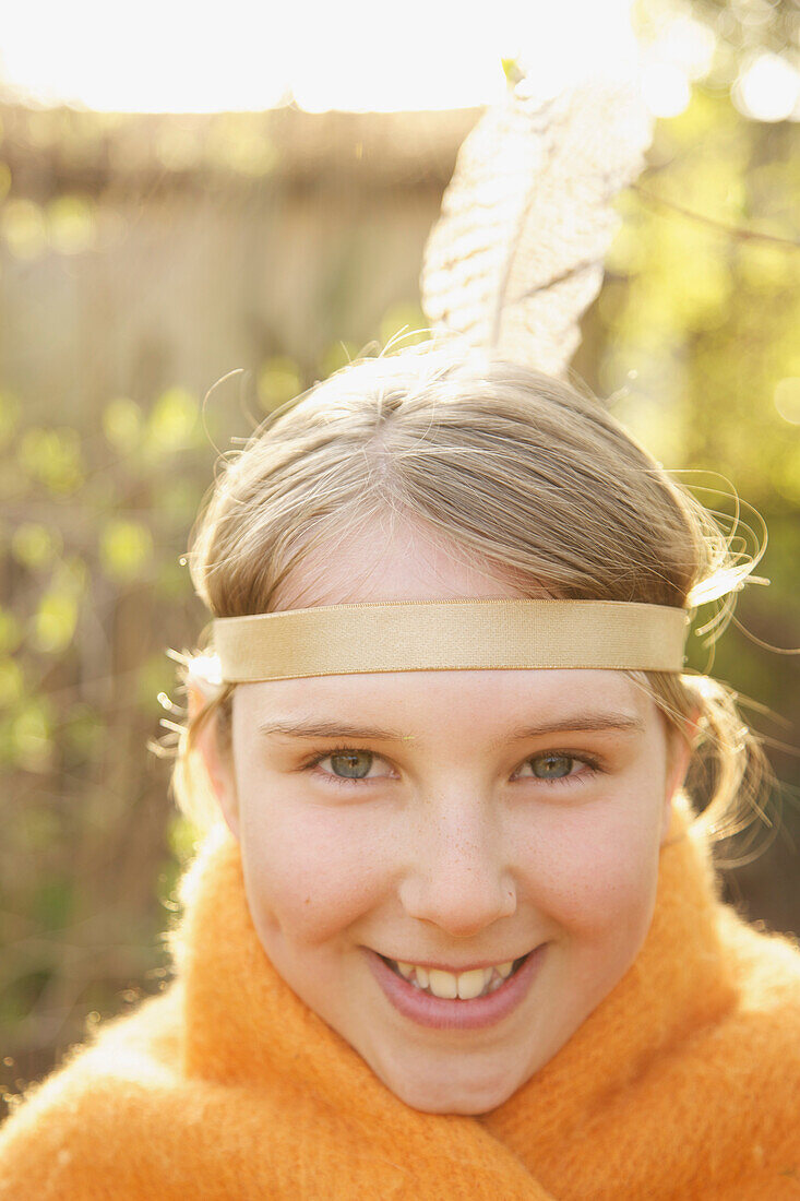 Close up of a girl wearing indian feather headdress