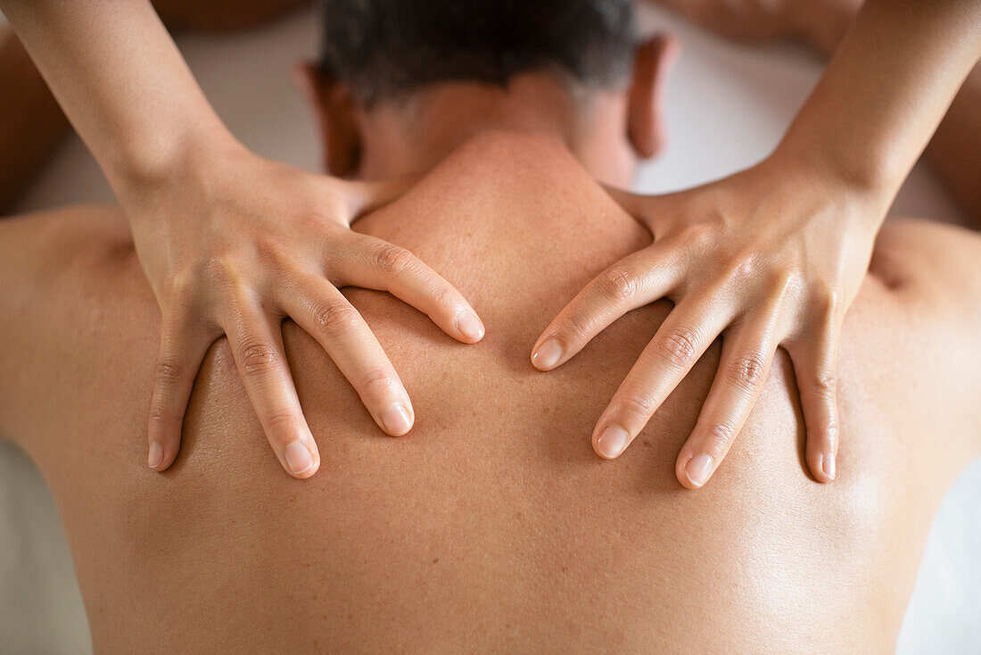 View from above man receiving shoulder massage at spa
