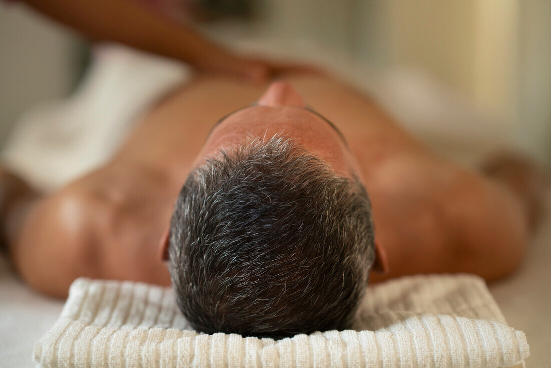 Man receiving massage in spa