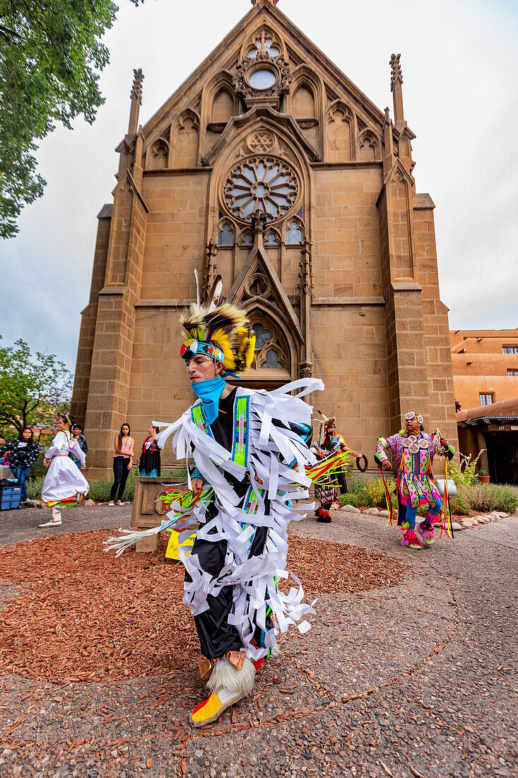 Santa Fe Indian Market participants in traditional regalia perform in downtown Santa Fe, New Mexico, United States of America, North America